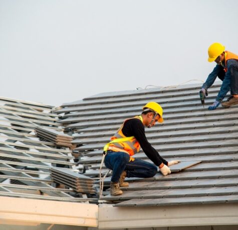 stock-photo-roofer-worker-in-special-protective-work-wear-and-gloves-using-pneumatic-gun-and-installing-1677474502-transformed-min