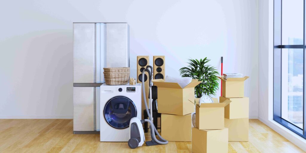 A room featuring a washing machine, vacuum cleaner, and various household items arranged neatly.