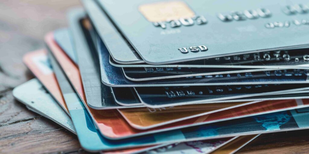 Credit cards stacked neatly on top of one another, showcasing various designs and colors.
