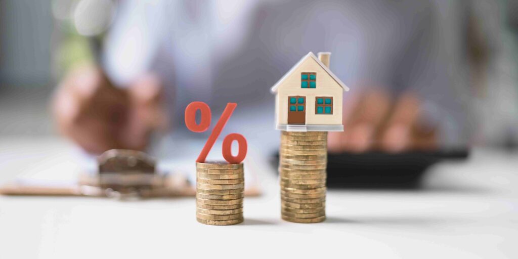 A picture shows coins and house model.